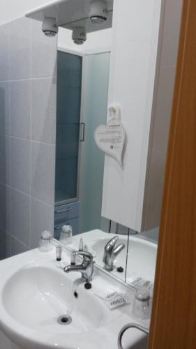 a bathroom with a sink and a mirror at Hotel Mimosa Pantheon in Rome