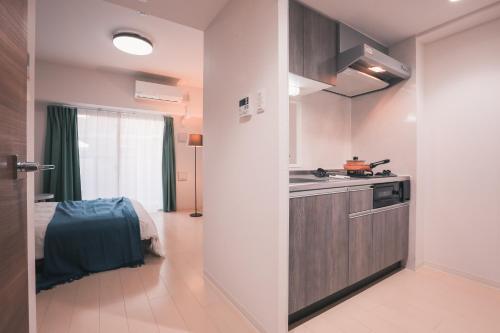 a kitchen with a sink and a counter top at 谷町君 星ホテル 新深江59 in Osaka