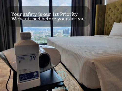 a bottle of milk sitting on a table next to a bed at Expressionz Professional Suites by MyKey in Kuala Lumpur