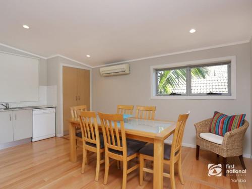a kitchen and dining room with a table and chairs at Angourie Blue 1 - Great Ocean Views - Surfing beaches in Yamba