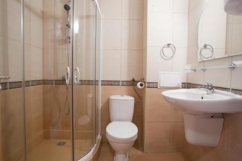 a bathroom with a toilet and a sink and a shower at Apartments in Central Plaza in Sunny Beach