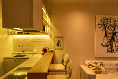 a kitchen with a counter and an elephant picture on the wall at Casa Azul in Lima