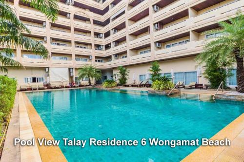 a swimming pool in front of a large building at View Talay Residence 6 Wongamat Beach in Pattaya North