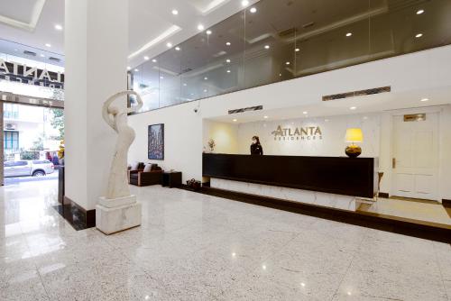 a lobby with a statue in the middle of a building at Atlanta Residences in Hanoi