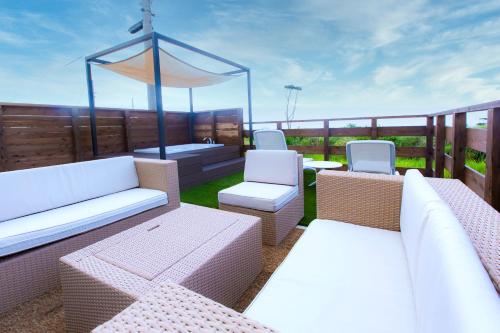 a patio with two couches and a table and chairs at Cinema Villa in Shushi