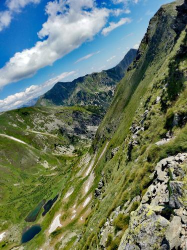 a mountain with green grass and rocks on it at Privat Mima in Liptovský Trnovec