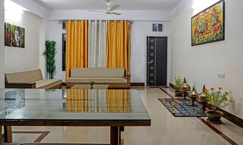 a living room with a table and a couch at Treebo Umal Homestay Ganeshguri in Guwahati