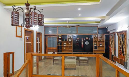a room with a hallway with a table and chairs at Treebo Umal Homestay Ganeshguri in Guwahati