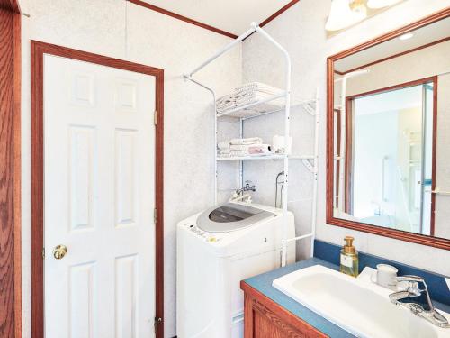 a bathroom with a sink and a washing machine at コテージスターハウス今帰仁 in Nakijin