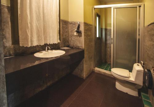 a bathroom with a toilet and a sink and a shower at Pai Panalee The Nature Boutique Hotel in Pai