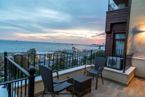 a balcony with chairs and a view of the ocean at Cheers Lighthouse in Istanbul