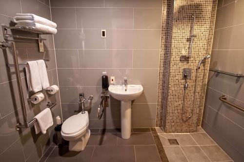 a bathroom with a toilet and a sink and a shower at Holiday Inn Gwangju by IHG in Gwangju