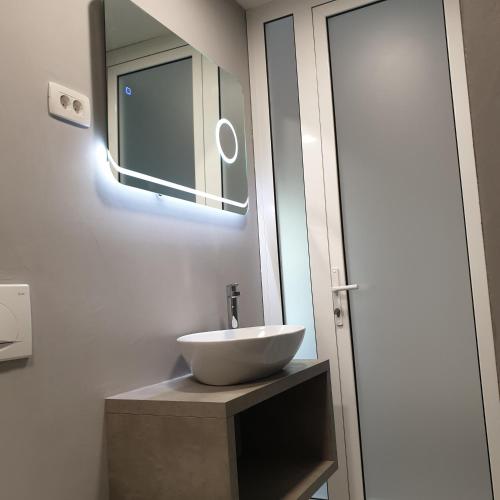 a bathroom with a white sink and a mirror at Apartma Pata, Koper - Čežarji in Čežarji