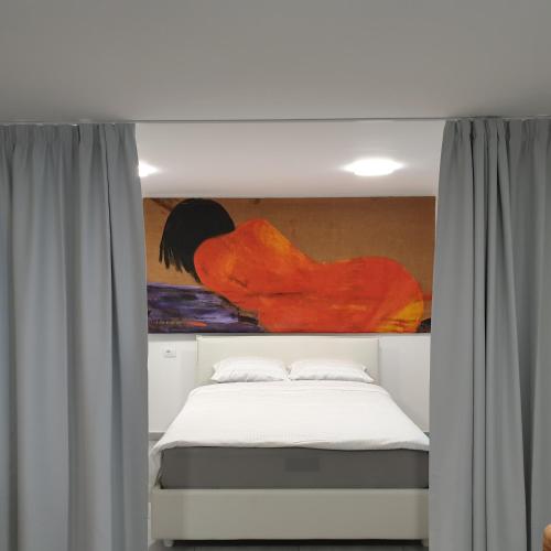a bedroom with a bed with a painting above it at Apartma Pata, Koper - Čežarji in Čežarji
