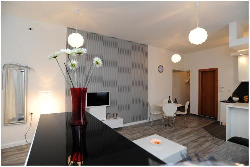 a living room with a vase with flowers on a table at Guest house D&G -I apartment & room in Zadar