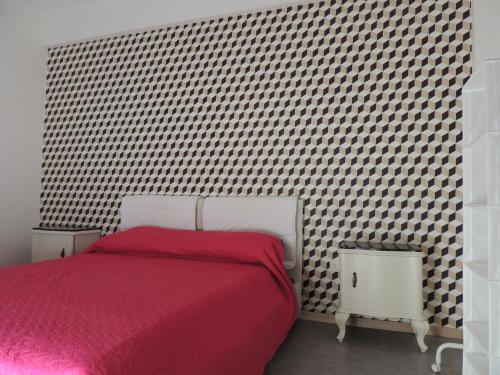a bedroom with a bed with a red blanket at Loft - Villa Flore apartments in villa in Casteldaccia