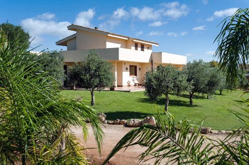 a white house with trees in front of it at Villa Laura in Marsala