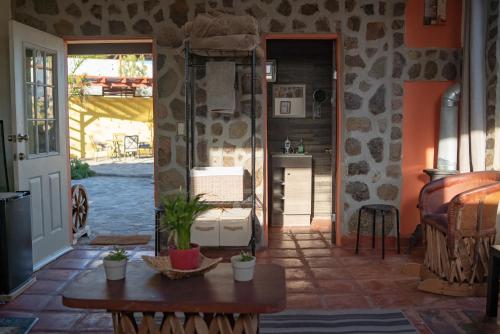 a living room with a table and a doorway at El Rincón Del Valle en la Ruta Del Vino in Valle de Guadalupe