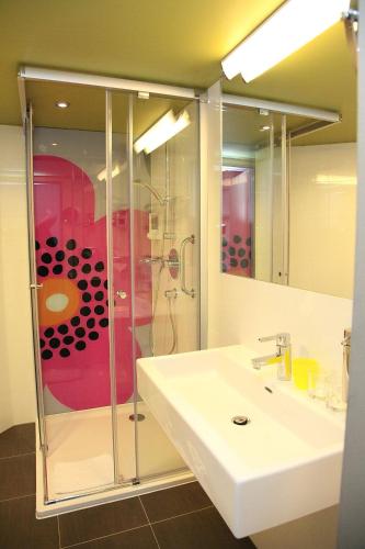 a bathroom with a sink and a shower at Kolping Family Resort in Hévíz