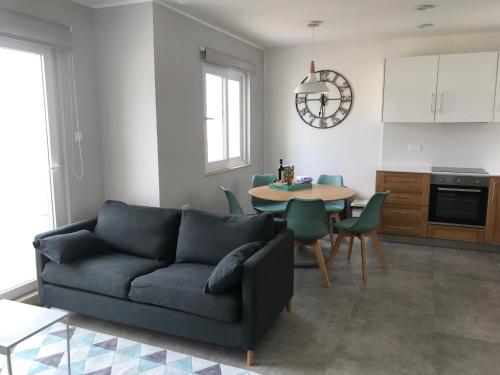 a living room with a couch and a table at The Three Trees Apartments in Sliema