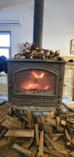 a fireplace with a fire inside of it at Biktot Ba Arafel in Nimrod