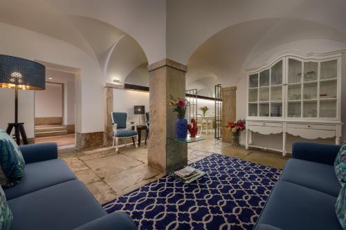 a living room with a blue couch and a blue rug at Alecrim ao Chiado in Lisbon