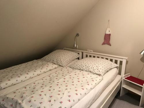 a bedroom with a bed with a white bedspread with birds on it at Ferienwohnung LOLA in Hohenlockstedt