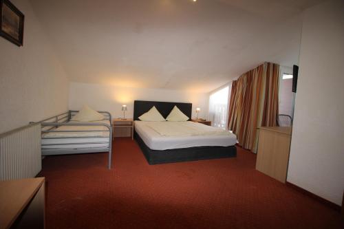 a hotel room with a bed and a window at Gasthof Götznerhof in Innsbruck