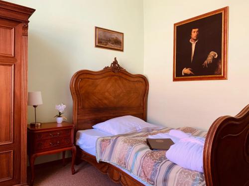 a bedroom with a bed with a laptop on it at Wellness hotel Rezidence in Nové Hrady