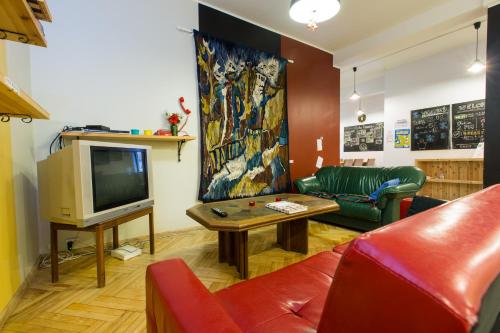a living room with a couch and a tv at Viru Backpackers Hostel in Tallinn
