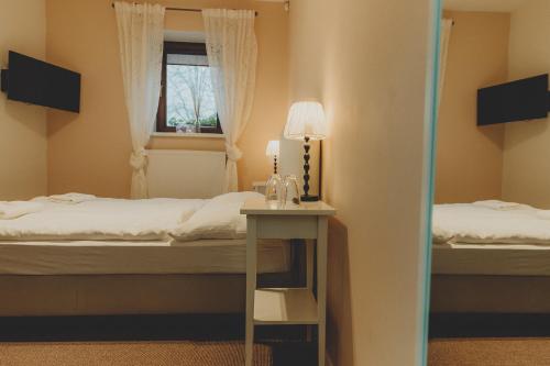 Postel nebo postele na pokoji v ubytování Penzion Nový Rybník