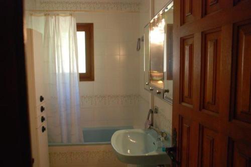 a bathroom with a sink and a bath tub at Casa Estany in L'Ametlla de Mar
