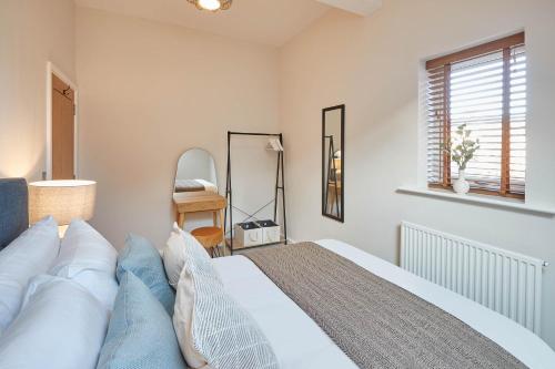 a bedroom with a large bed and a mirror at Host & Stay - Skyline Apartment in Whitby