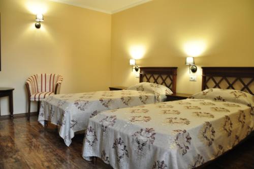 Ένα ή περισσότερα κρεβάτια σε δωμάτιο στο Vigo Grand Hotel