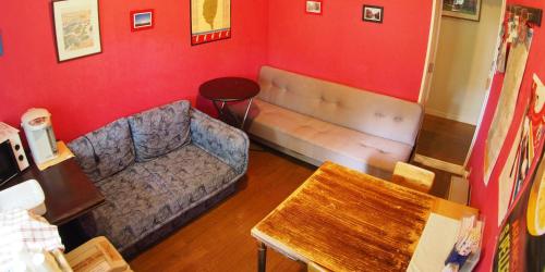 a living room with a couch and a table at Bellscabin Guesthouse in Karuizawa