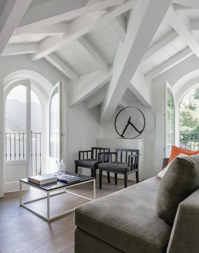 a living room with a couch and a table at Villa Làrio Lake Como in Pognana Lario