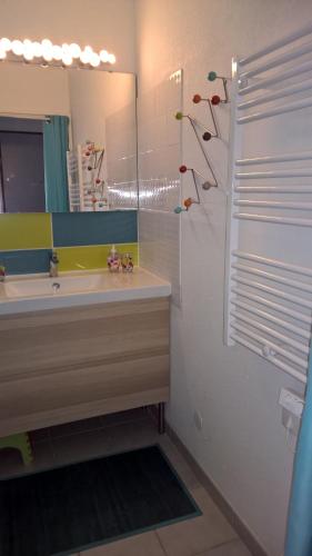 une salle de bain avec un lavabo et un miroir dans l'établissement appartement 58 m 2 en 1 ere ligne ,vue mer panoramique ,2 terrasses dont une couverte résidence le Sunset, au Cap d'Agde