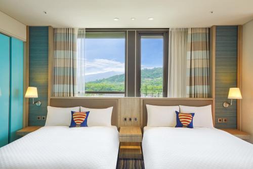 Postel nebo postele na pokoji v ubytování Hotel Cham Cham Taitung Caesar Park Hotels & Resort