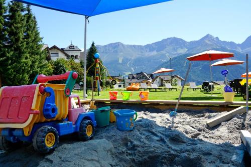 a toy truck in the sand in a playground at Apart-Hotel Dreisonnenhof in Fiss