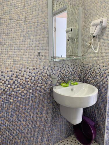 a bathroom with a sink and a mirror at Вита Гагра in Gagra