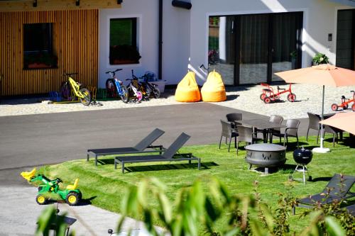a patio with chairs and tables and motorcycles on the grass at Apart-Hotel Dreisonnenhof in Fiss
