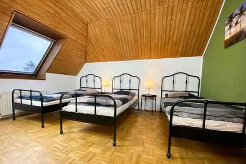 Ce dortoir comprend 3 lits superposés et une fenêtre. dans l'établissement Work & Stay Boardinghouse Werwolf by Teamflats, à Solingen