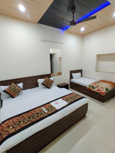 a bedroom with two beds in a room at RUJHAN in Amritsar