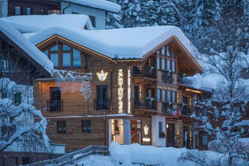 a lodge in the snow with snow covered trees at Schindler in Sankt Anton am Arlberg