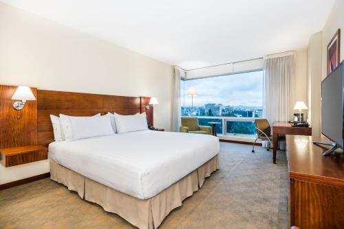 a hotel room with a bed and a large window at Holiday Inn Express Quito by IHG in Quito