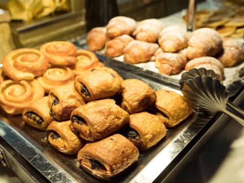 a bunch of pastries on trays in a bakery at Gardaland Adventure Hotel in Castelnuovo del Garda