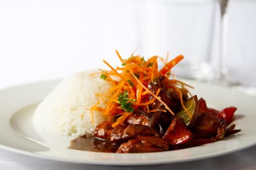 a plate of food with rice and meat and carrots at Wellness hotel Rezidence in Nové Hrady