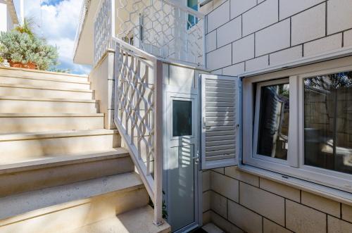 a house with a staircase and a window at Guesthouse Matusic in Dubrovnik