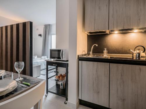 a kitchen with a sink and a microwave at COZY studio-flat in PACEVILLE in St. Julianʼs
