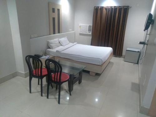 מיטה או מיטות בחדר ב-HOTEL ARYAN INTERNATIONAL